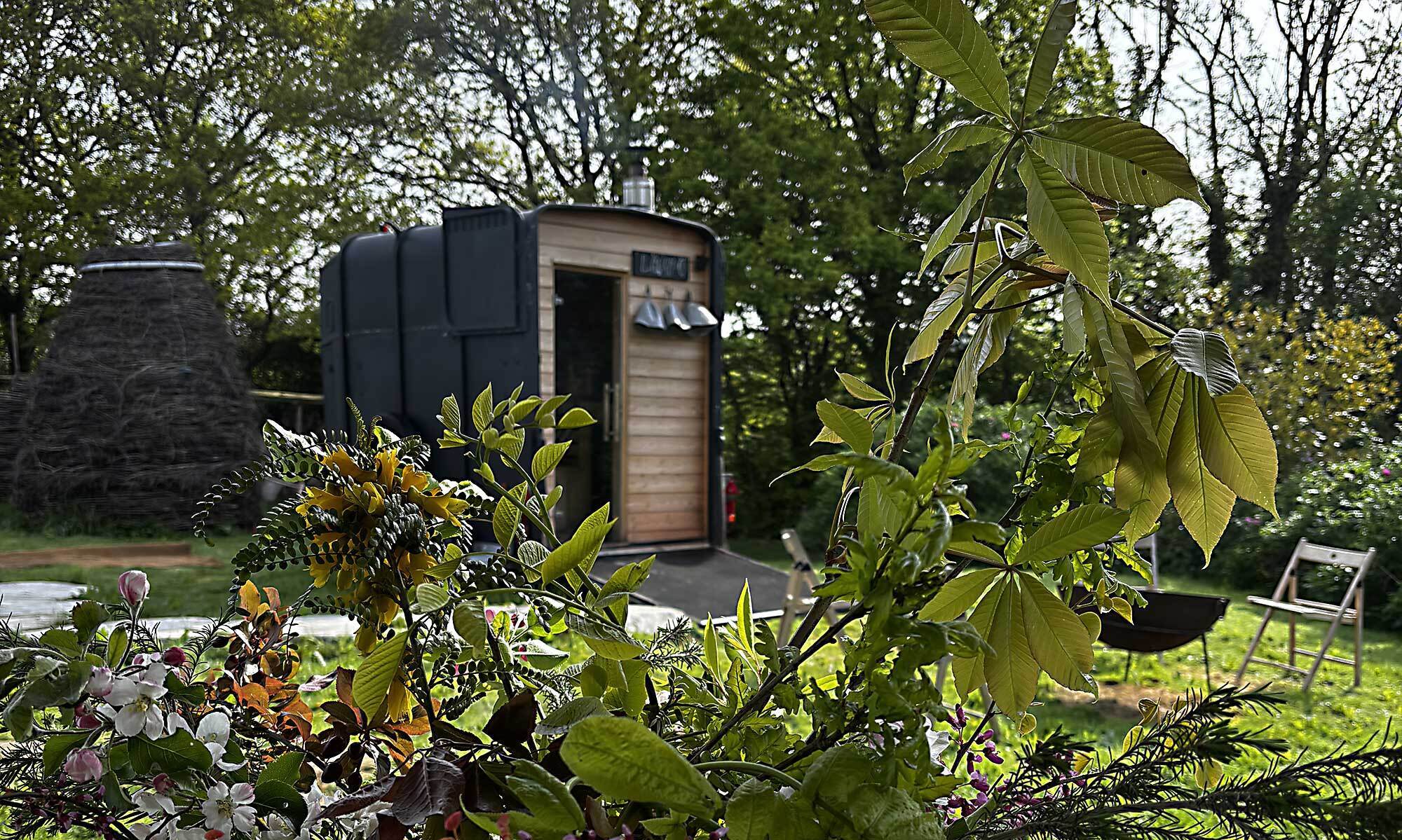 LogJam Sauna horse-box trailer in the cider orchard during a private session, East Sussex